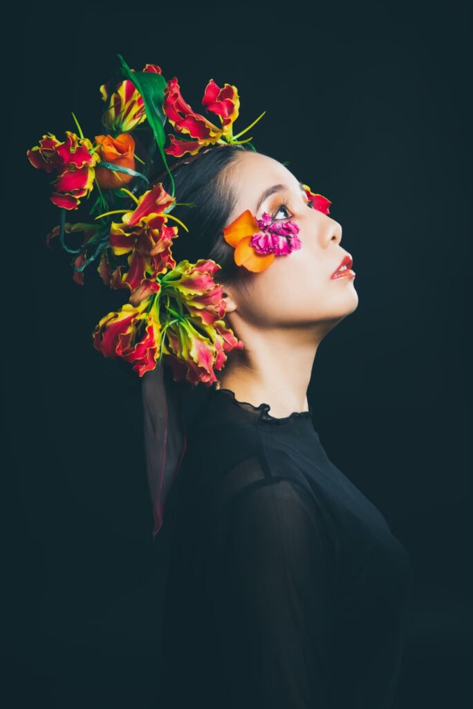Head shot of Kyoko Fujimoto wearing a floral headdress.